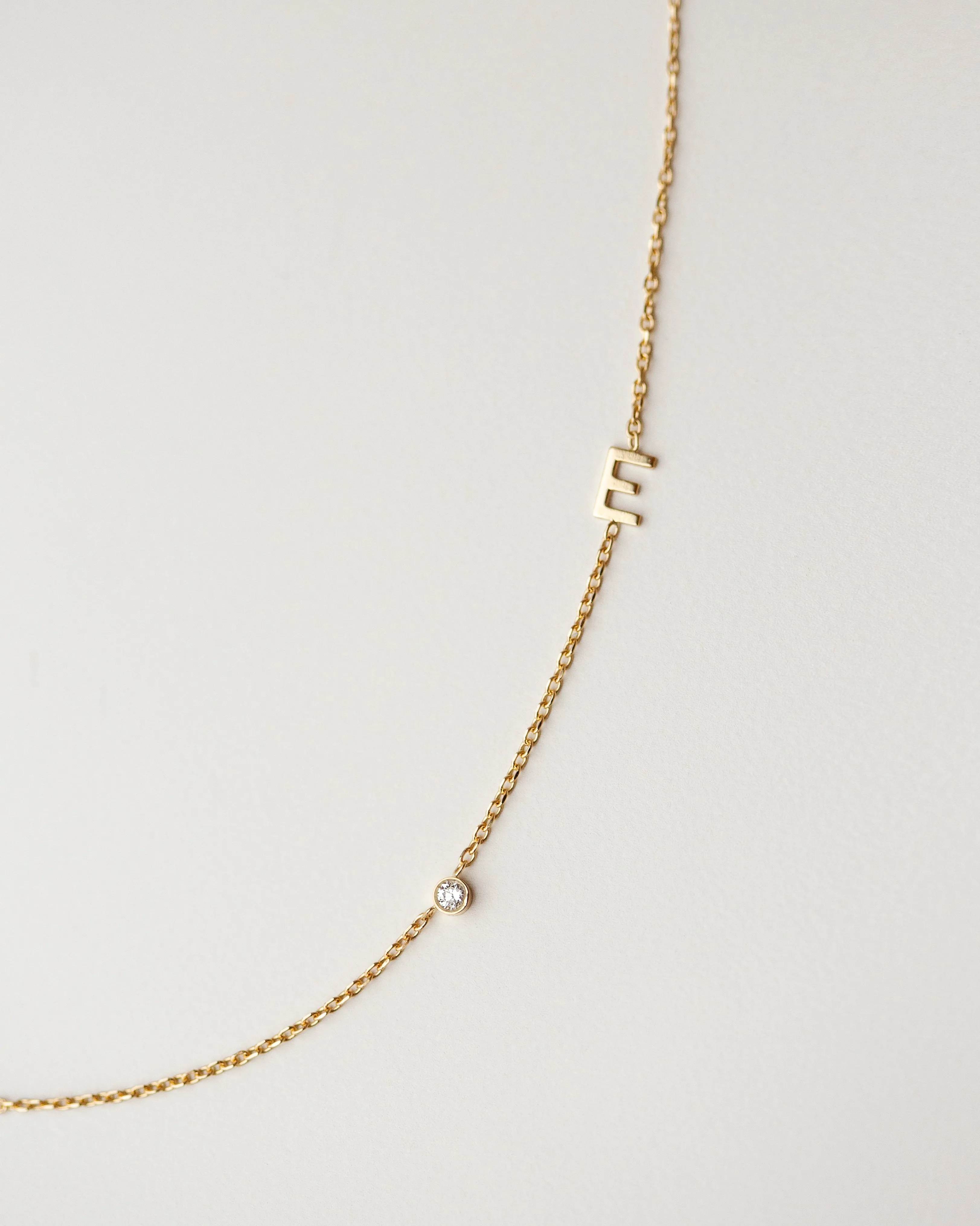 14k gold letter necklace with small diamond