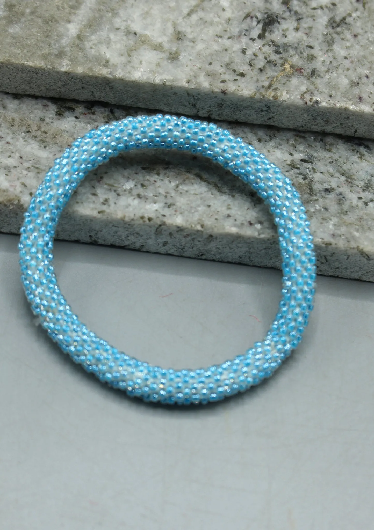 Shiny Light Blue Beads Nepalese Roll on Bracelet